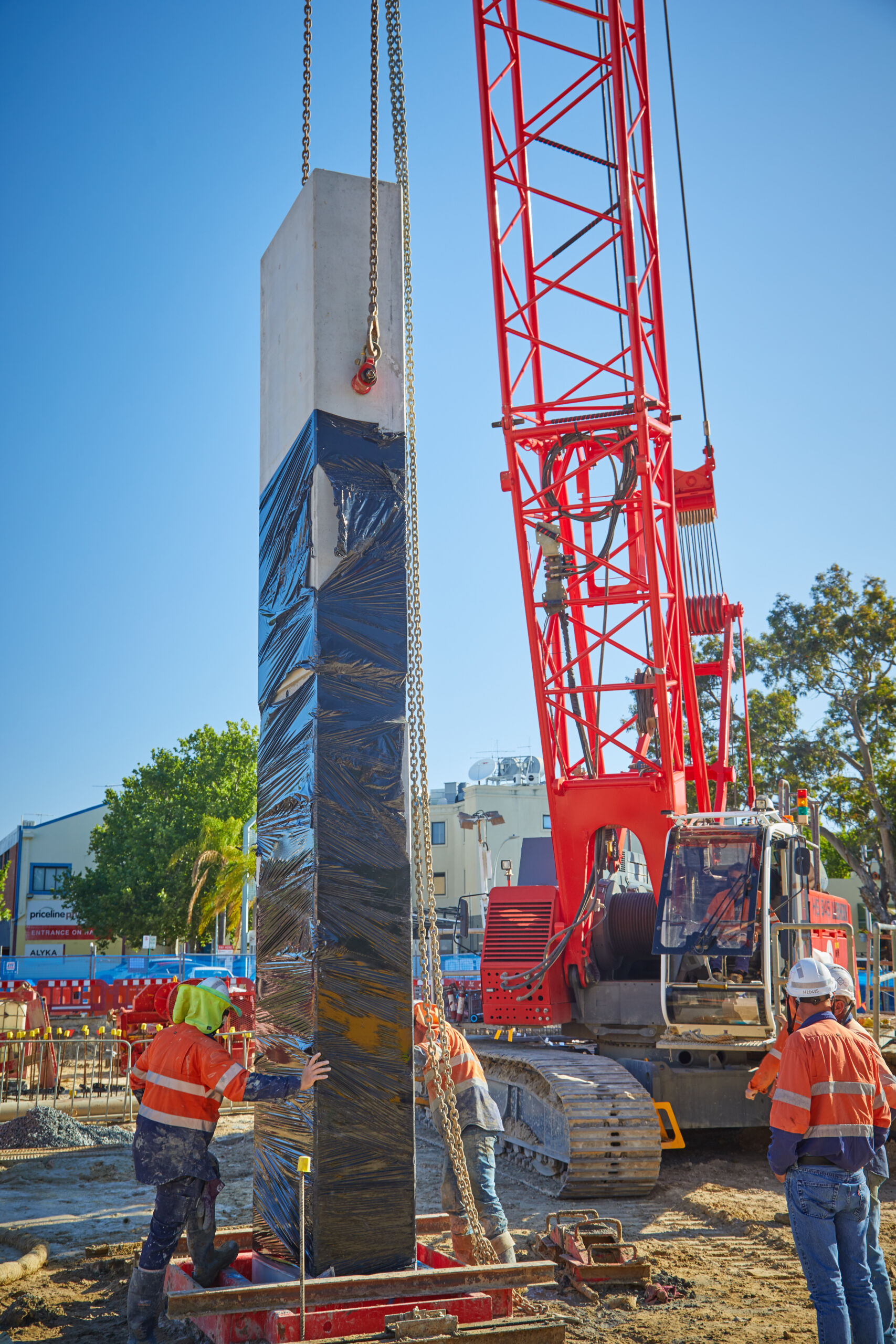 Lowering a precast concrete plunge column for robust foundations at One Subiaco in Perth, Western Australia